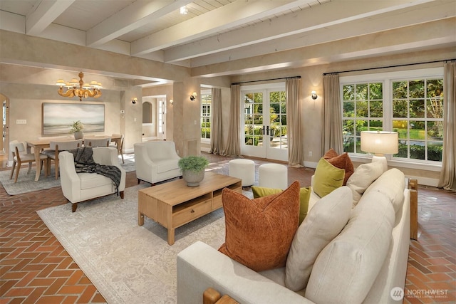 1135 Evergreen Point Rd, Medina, WA 98039 - living room featuring brick flooring, a chandelier, beamed ceiling, french doors, and arched walkways