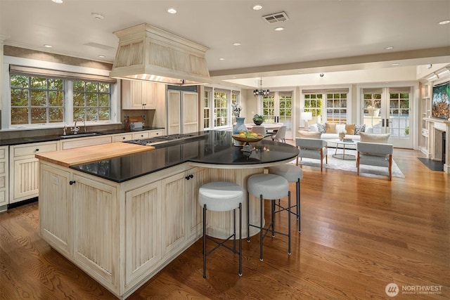 1135 Evergreen Point Rd, Medina, WA 98039 - kitchen with open floor plan, stainless steel gas stovetop, a kitchen island, wood finished floors, and recessed lighting
