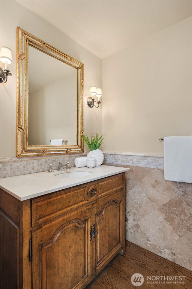1135 Evergreen Point Rd, Medina, WA 98039 - bathroom featuring vanity, tile walls, wainscoting, and wood finished floors