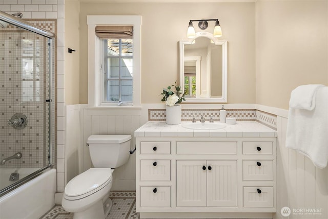 1135 Evergreen Point Rd, Medina, WA 98039 - full bathroom with a wainscoted wall, vanity, combined bath / shower with glass door, and tile patterned floors