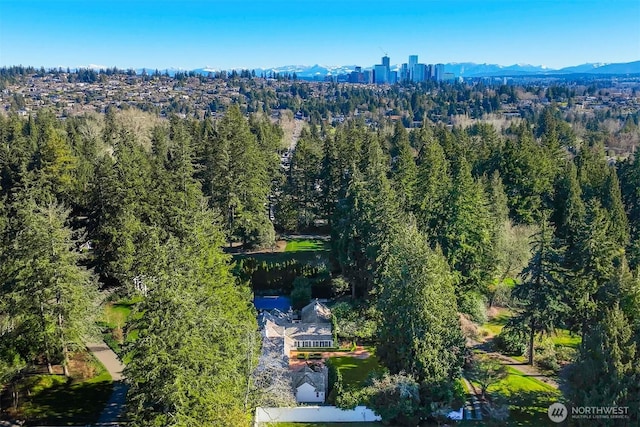1135 Evergreen Point Rd, Medina, WA 98039 - drone / aerial view of a heavily wooded area and a mountain backdrop