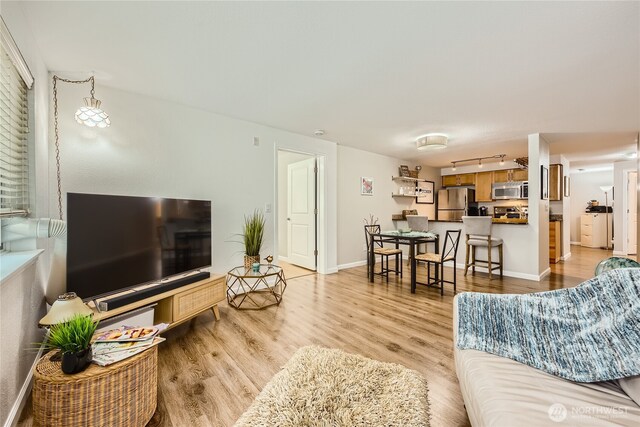 3045 20th Ave W Unit 108, Seattle, WA 98199 - living area featuring light wood-style floors and baseboards