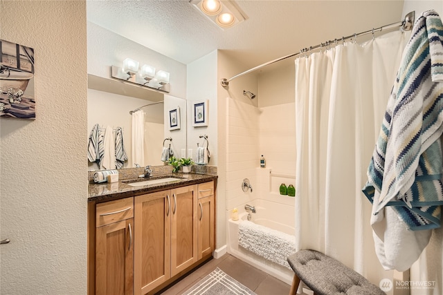 3045 20th Ave W Unit 108, Seattle, WA 98199 - full bath featuring shower / bath combo with shower curtain, vanity, a textured ceiling, a textured wall, and tile patterned flooring
