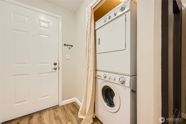 3045 20th Ave W Unit 108, Seattle, WA 98199 - laundry room with stacked washer / dryer and light wood-style flooring