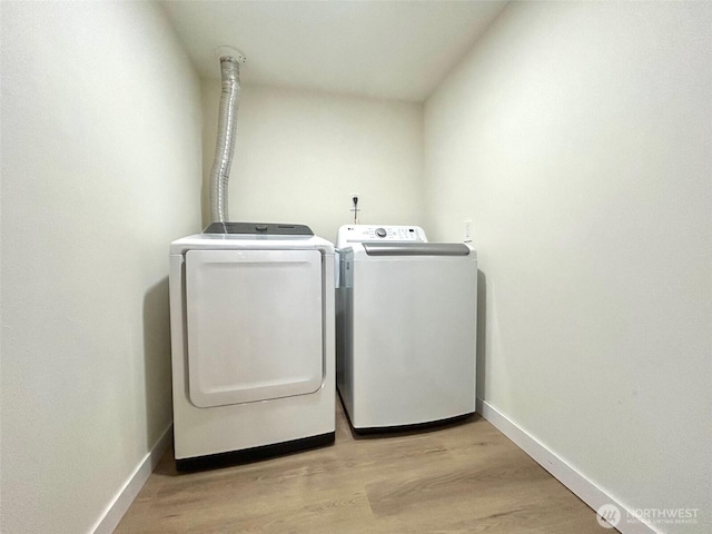 7353 29th Ave SW, Seattle, WA 98126 - laundry area featuring washer and dryer and light wood-style flooring