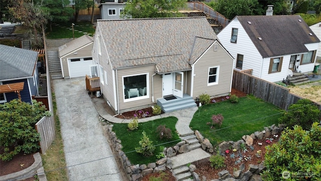 7353 29th Ave SW, Seattle, WA 98126 - view of front of home featuring a garage, roof with shingles, and a fenced backyard