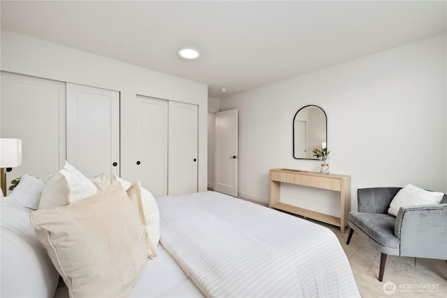 2439 NW 61st St Unit A, Seattle, WA 98107 - bedroom featuring two closets and baseboards
