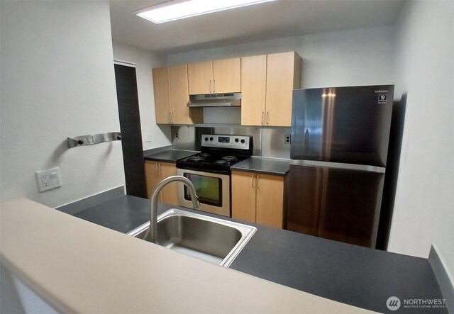 510 S 325th St Unit 19G, Federal Way, WA 98003 - kitchen with freestanding refrigerator, stainless steel range with electric cooktop, under cabinet range hood, and light brown cabinets