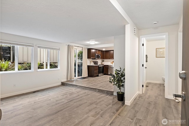 12718 NE 120th St Unit J-2, Kirkland, WA 98034 - corridor featuring baseboards and light wood-style flooring