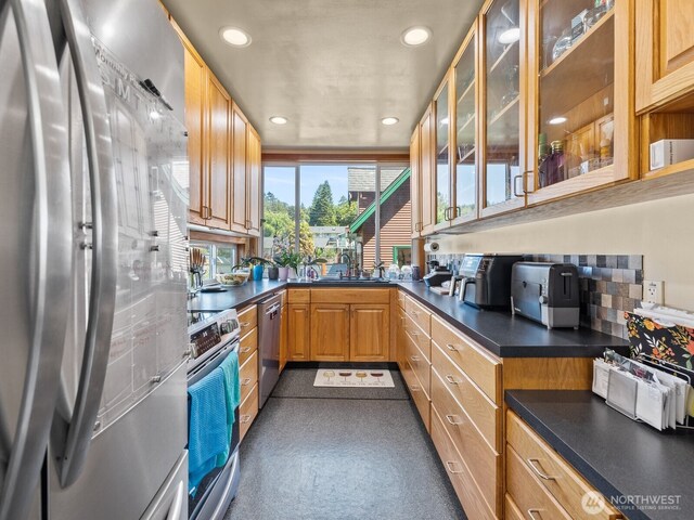 139 Maple St, Camano Island, WA 98282 - kitchen featuring appliances with stainless steel finishes, dark countertops, recessed lighting, and glass insert cabinets
