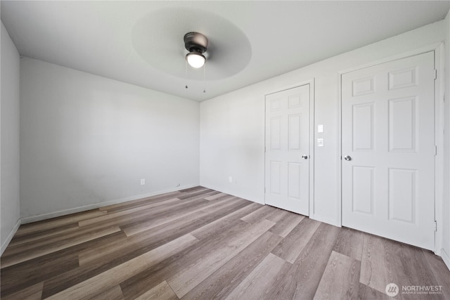 325 S 8th Ave, Othello, WA 99344 - unfurnished bedroom featuring wood finished floors and a ceiling fan
