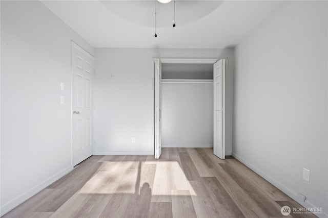 325 S 8th Ave, Othello, WA 99344 - unfurnished bedroom featuring wood finished floors, a closet, and ceiling fan