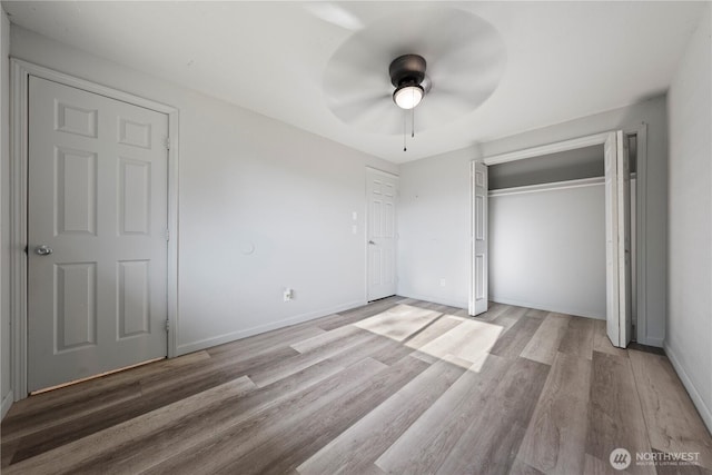 325 S 8th Ave, Othello, WA 99344 - unfurnished bedroom with light wood-type flooring, a closet, and a ceiling fan