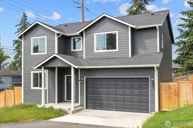 711 S 96th St, Tacoma, WA 98444 - traditional-style home featuring an attached garage, roof with shingles, and driveway