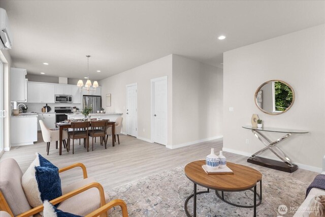 711 S 96th St, Tacoma, WA 98444 - living room featuring a chandelier, light wood-type flooring, recessed lighting, and a wall unit AC