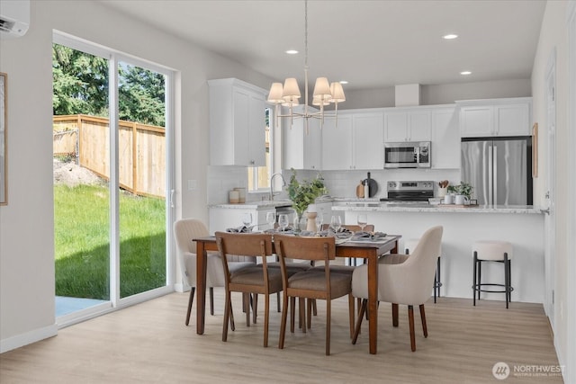 711 S 96th St, Tacoma, WA 98444 - dining space featuring a chandelier, light wood-style flooring, a wall mounted AC, and recessed lighting