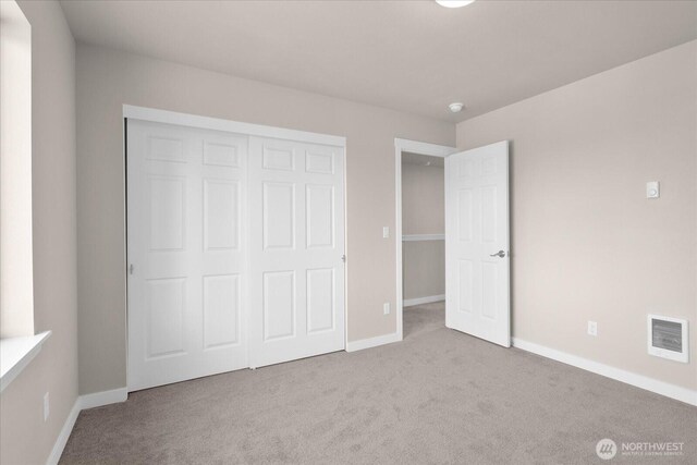 711 S 96th St, Tacoma, WA 98444 - unfurnished bedroom featuring carpet and a closet