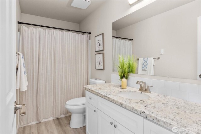 711 S 96th St, Tacoma, WA 98444 - bathroom featuring vanity, wood finished floors, and a shower with curtain