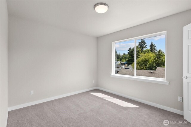 711 S 96th St, Tacoma, WA 98444 - empty room featuring carpet flooring and baseboards
