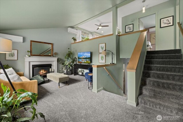 35632 158th St SE, Sultan, WA 98294 - living area featuring carpet floors, a wall unit AC, a lit fireplace, a ceiling fan, and lofted ceiling