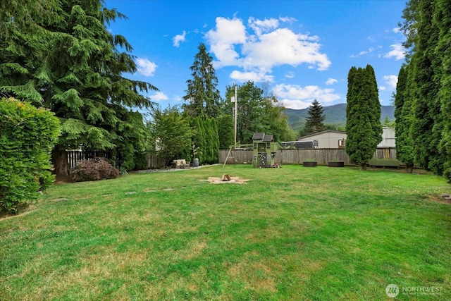 35632 158th St SE, Sultan, WA 98294 - fenced backyard with a playground and a mountain view