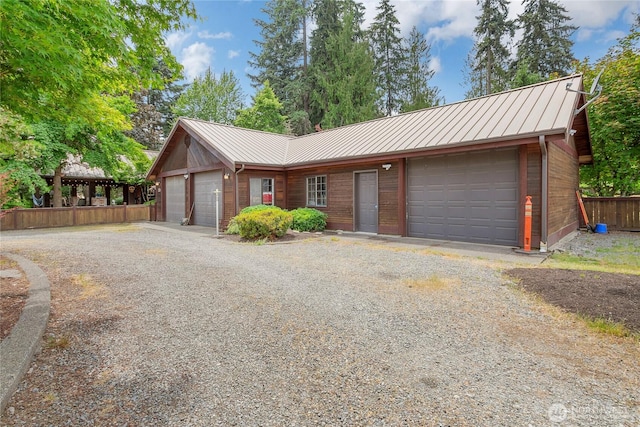 19127 Patterson Rd E, Orting, WA 98360 - view of front of house with a metal roof, a standing seam roof, and a detached garage