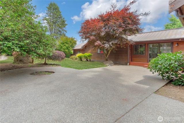 19127 Patterson Rd E, Orting, WA 98360 - view of side of property featuring a metal roof