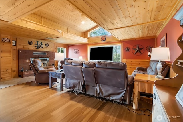 19127 Patterson Rd E, Orting, WA 98360 - living room featuring wood ceiling, wooden walls, light wood-type flooring, a fireplace, and a wainscoted wall
