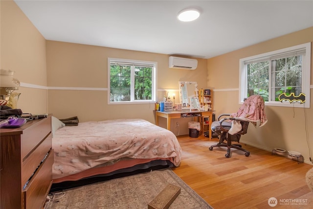 19127 Patterson Rd E, Orting, WA 98360 - bedroom with a wall mounted air conditioner and light wood-style flooring