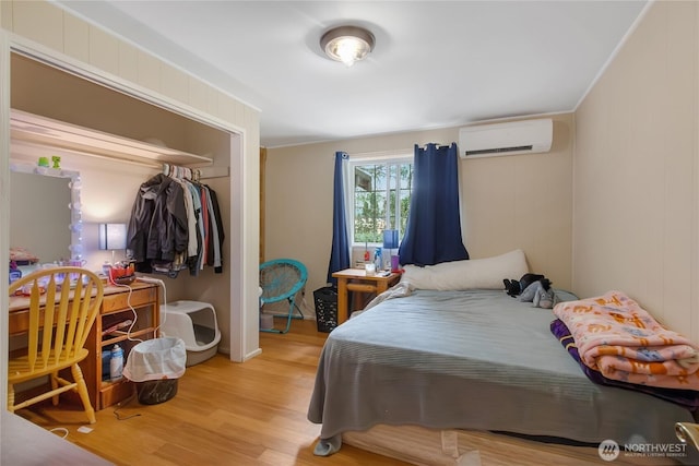 19127 Patterson Rd E, Orting, WA 98360 - bedroom with an AC wall unit, wood finished floors, and a closet
