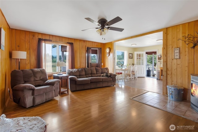 19127 Patterson Rd E, Orting, WA 98360 - living area with wood walls, ceiling fan, and wood finished floors