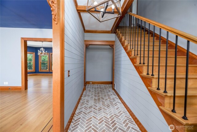 11801 Rd 5.6 NE, Moses Lake, WA 98837 - stairs with a chandelier, wood walls, and brick patterned flooring