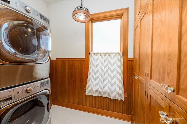 11801 Rd 5.6 NE, Moses Lake, WA 98837 - laundry room featuring stacked washer / drying machine, a wainscoted wall, and wooden walls