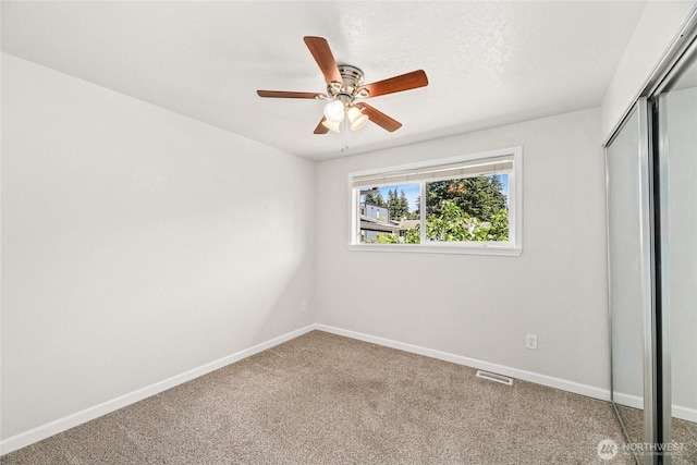 13045 28th Ave NE, Seattle, WA 98125 - unfurnished bedroom with a closet, carpet flooring, and ceiling fan