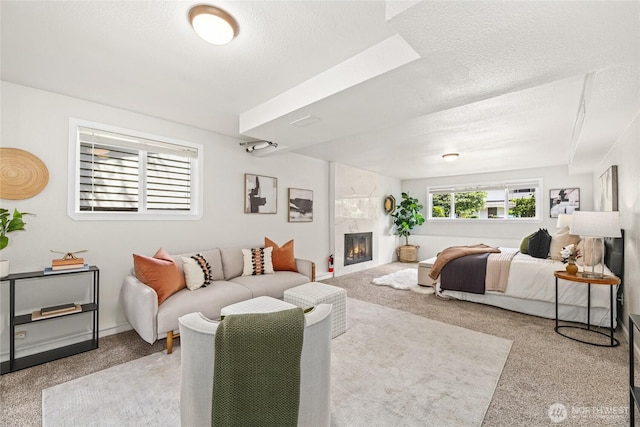 13045 28th Ave NE, Seattle, WA 98125 - bedroom featuring carpet flooring, a fireplace, and a textured ceiling