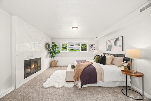 13045 28th Ave NE, Seattle, WA 98125 - carpeted bedroom featuring a high end fireplace