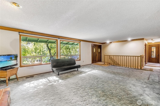 8419 121st St E, Puyallup, WA 98373 - sitting room with a textured ceiling, carpet, and an upstairs landing