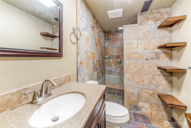 8419 121st St E, Puyallup, WA 98373 - full bathroom featuring stone tile floors, walk in shower, and vanity