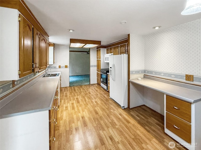 8419 121st St E, Puyallup, WA 98373 - kitchen with white appliances, wallpapered walls, light wood finished floors, recessed lighting, and light countertops