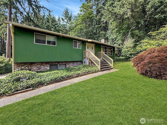 8419 121st St E, Puyallup, WA 98373 - view of front of property with a chimney, a front lawn, and an attached garage