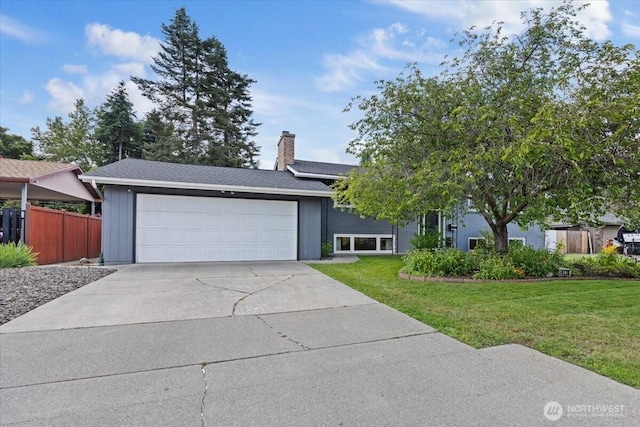 4128 S Lee St, Spokane, WA 99203 - view of front of house featuring a garage, a chimney, and concrete driveway