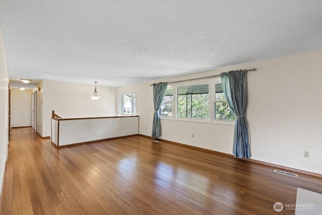 4128 S Lee St, Spokane, WA 99203 - spare room featuring wood finished floors and a textured ceiling