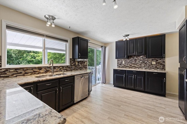 4128 S Lee St, Spokane, WA 99203 - kitchen featuring dishwasher, decorative backsplash, dark cabinets, light wood finished floors, and a textured ceiling