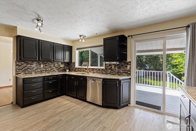 4128 S Lee St, Spokane, WA 99203 - kitchen with dishwasher, light wood finished floors, decorative backsplash, dark cabinetry, and a textured ceiling