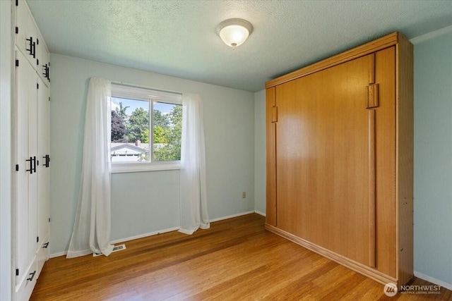 4128 S Lee St, Spokane, WA 99203 - unfurnished bedroom with light wood-type flooring and a textured ceiling