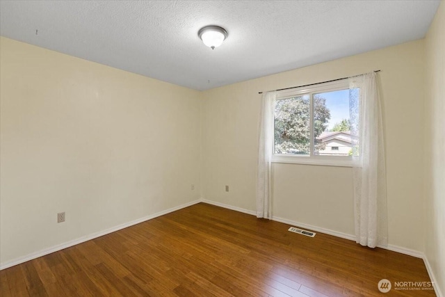 4128 S Lee St, Spokane, WA 99203 - spare room featuring wood finished floors and a textured ceiling