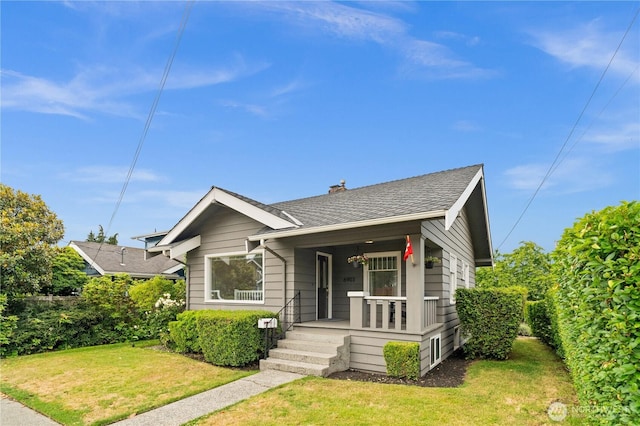 6903 Fauntleroy Way SW, Seattle, WA 98136 - bungalow-style house with a porch, a front lawn, a chimney, and a shingled roof