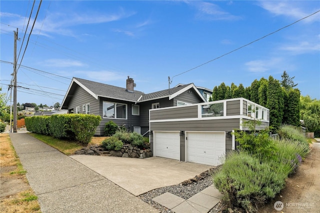 6903 Fauntleroy Way SW, Seattle, WA 98136 - view of front of property with concrete driveway, a garage, a balcony, and a chimney