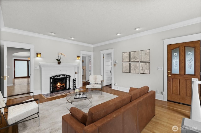6903 Fauntleroy Way SW, Seattle, WA 98136 - living room with light wood finished floors, crown molding, a fireplace with flush hearth, recessed lighting, and a textured ceiling