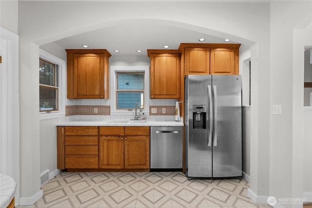 6903 Fauntleroy Way SW, Seattle, WA 98136 - kitchen with appliances with stainless steel finishes, recessed lighting, brown cabinets, tasteful backsplash, and light floors